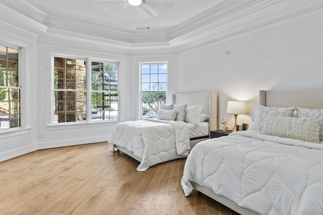 bedroom with light wood-type flooring, ceiling fan, and ornamental molding