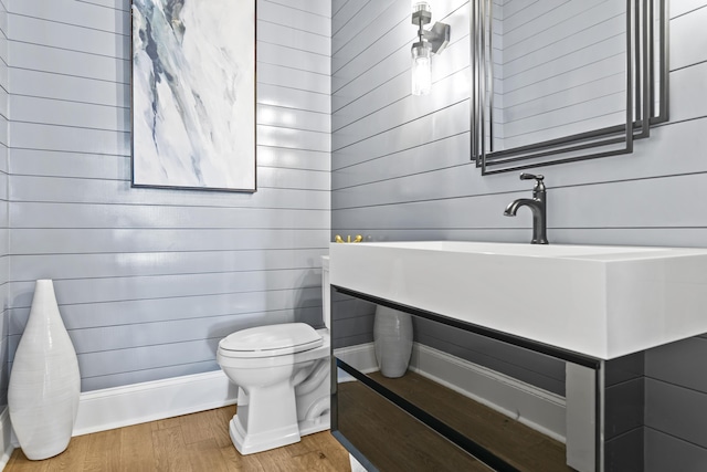 bathroom with toilet and wood-type flooring