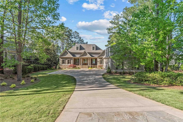 new england style home with covered porch and a front yard