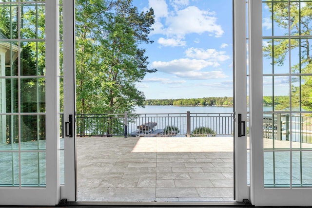 doorway to outside with a water view and a wealth of natural light