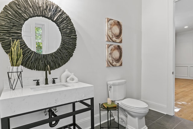 bathroom with sink, toilet, and tile patterned floors