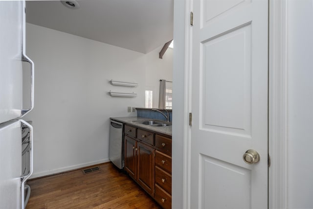 bathroom with visible vents, vanity, baseboards, and wood finished floors