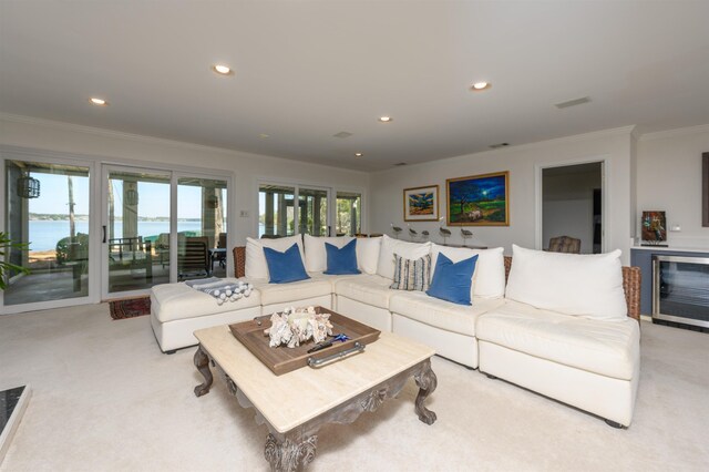 261 Reynolds Dr, Eatonton, GA 31024 - living area with light colored carpet, ornamental molding, a water view, recessed lighting, and beverage cooler