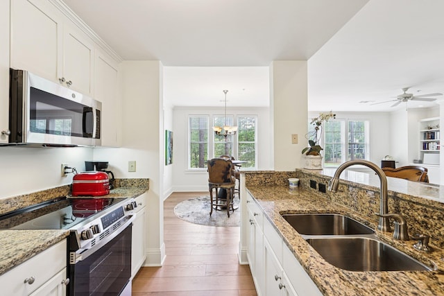 1010A Creekside, Greensboro, GA 30642 - kitchen with appliances with stainless steel finishes, a sink, plenty of natural light, and wood finished floors