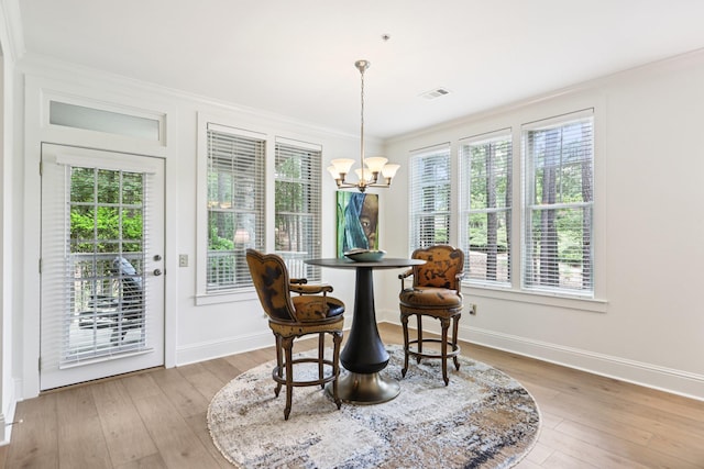 1010A Creekside, Greensboro, GA 30642 - dining space with a chandelier, ornamental molding, baseboards, and light wood-style flooring