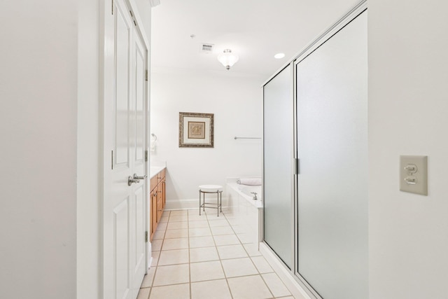 1010A Creekside, Greensboro, GA 30642 - bathroom with vanity, tile patterned flooring, a garden tub, baseboards, and a stall shower