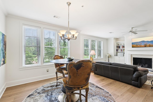 1010A Creekside, Greensboro, GA 30642 - dining space featuring light wood-style flooring, a chandelier, ornamental molding, baseboards, and ceiling fan