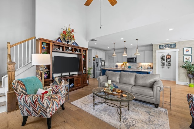 1181 Hidden Hills Cir, Greensboro, GA 30642 - living room with recessed lighting, light wood-style flooring, a ceiling fan, and stairway