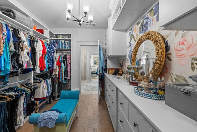 1181 Hidden Hills Cir, Greensboro, GA 30642 - walk in closet featuring a chandelier and wood finished floors