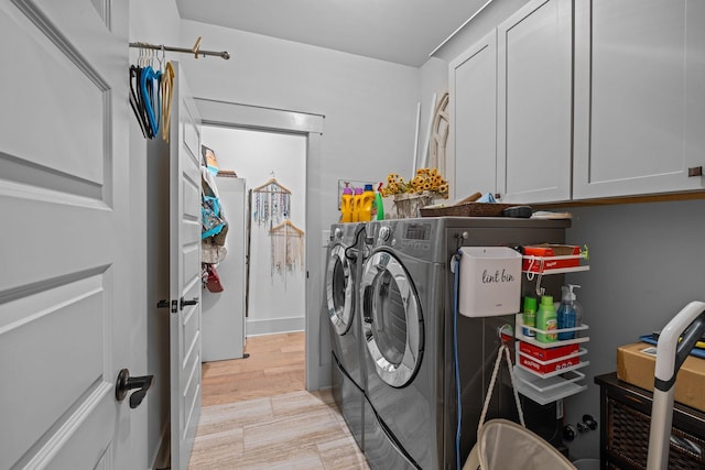 1181 Hidden Hills Cir, Greensboro, GA 30642 - laundry room with washer and clothes dryer, cabinet space, and light wood-style floors