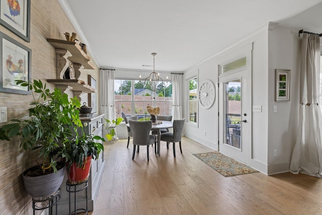 1181 Hidden Hills Cir, Greensboro, GA 30642 - dining room with light wood finished floors, crown molding, and a chandelier