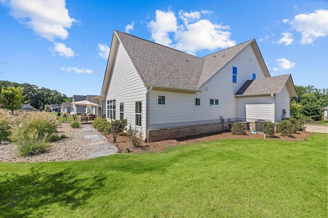 1181 Hidden Hills Cir, Greensboro, GA 30642 - rear view of house featuring roof with shingles, a yard, and a patio area