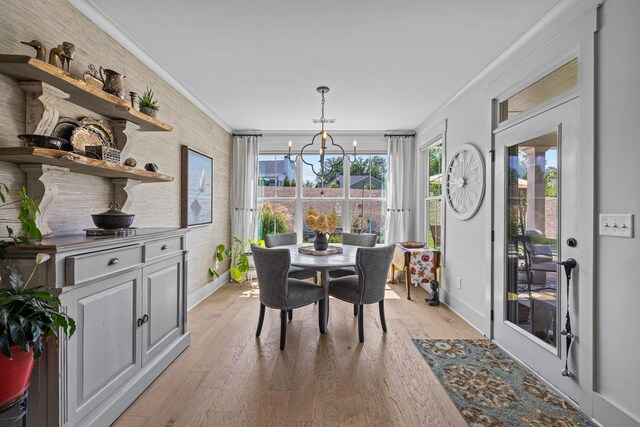 1181 Hidden Hills Cir, Greensboro, GA 30642 - dining area featuring ornamental molding, a chandelier, and light wood finished floors