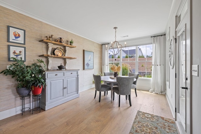 1181 Hidden Hills Cir, Greensboro, GA 30642 - dining space with a chandelier, light wood finished floors, and crown molding