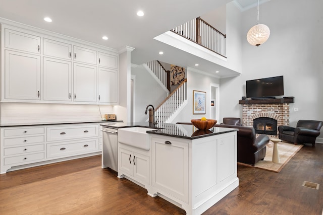 855 Jasper St, Madison, GA 30650 - kitchen featuring dark countertops, dishwasher, ornamental molding, a fireplace, and white cabinets