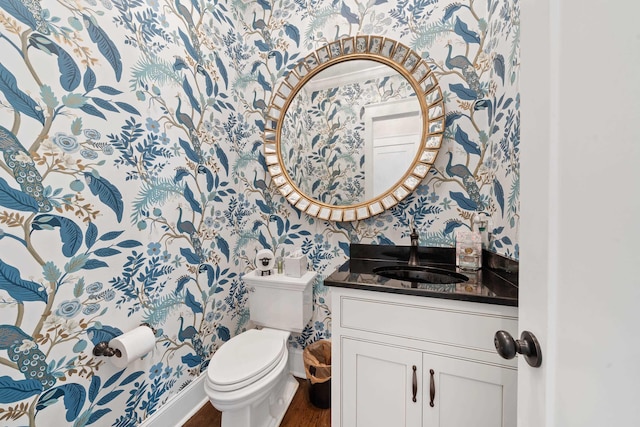 855 Jasper St, Madison, GA 30650 - half bath featuring wallpapered walls, vanity, and wood finished floors