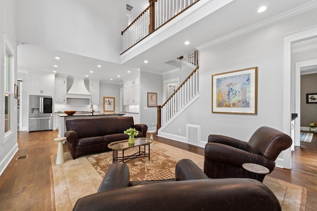 855 Jasper St, Madison, GA 30650 - living room with wood finished floors, a high ceiling, stairway, crown molding, and recessed lighting