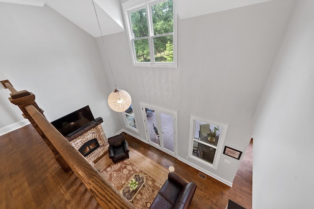 855 Jasper St, Madison, GA 30650 - living area with wood finished floors, high vaulted ceiling, and a brick fireplace