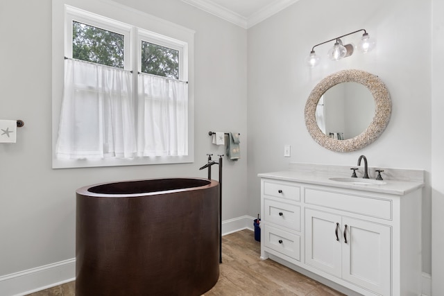 855 Jasper St, Madison, GA 30650 - bathroom featuring vanity, ornamental molding, and wood finished floors