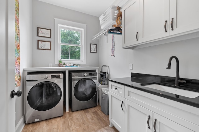 855 Jasper St, Madison, GA 30650 - washroom with cabinet space, washer and clothes dryer, and light wood-style flooring