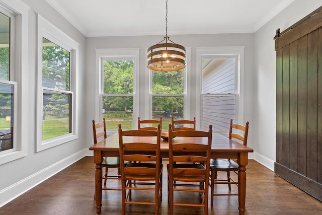 855 Jasper St, Madison, GA 30650 - dining space featuring dark wood finished floors, ornamental molding, a barn door, and a chandelier