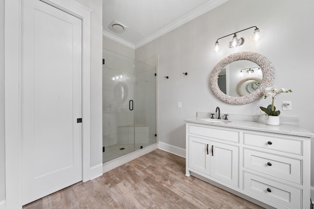 855 Jasper St, Madison, GA 30650 - bathroom with a stall shower, ornamental molding, vanity, and wood finished floors