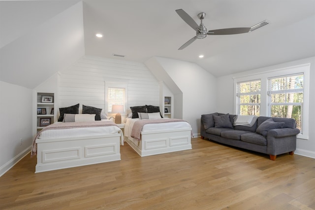 bedroom featuring vaulted ceiling, visible vents, and light wood finished floors