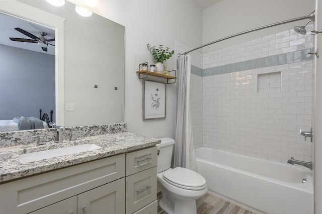 full bathroom featuring toilet, wood finished floors, shower / tub combo, ceiling fan, and vanity