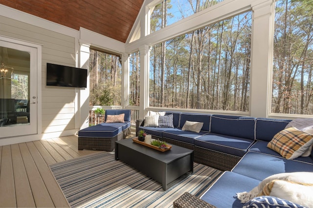 sunroom / solarium featuring vaulted ceiling