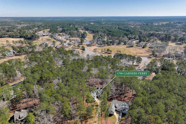 drone / aerial view with a view of trees and a water view