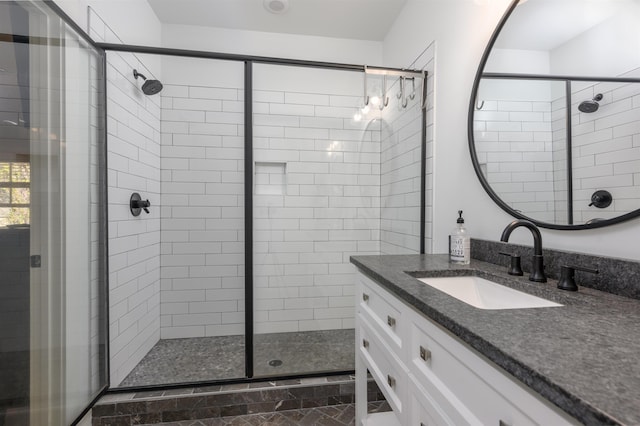 full bathroom with a stall shower and vanity