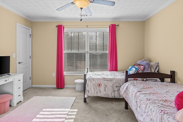 bedroom with crown molding, light colored carpet, ceiling fan, and a textured ceiling