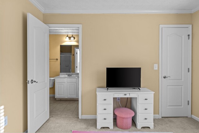 office area featuring ornamental molding, sink, and light carpet