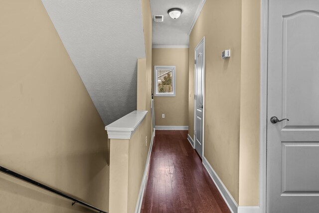 hallway with crown molding and dark wood-type flooring