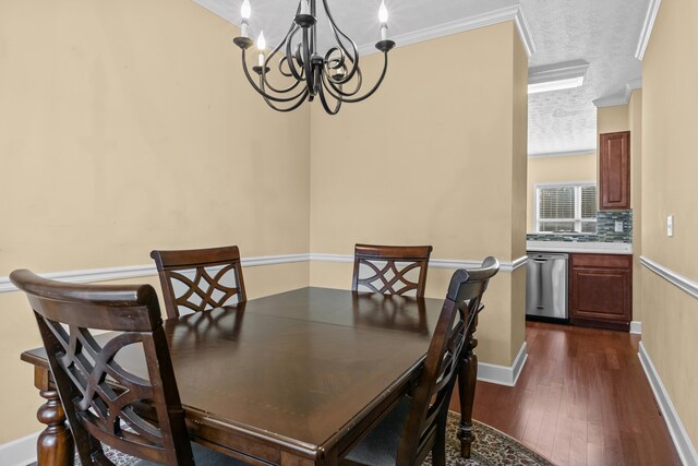 dining space with dark hardwood / wood-style flooring, a textured ceiling, ornamental molding, and a chandelier