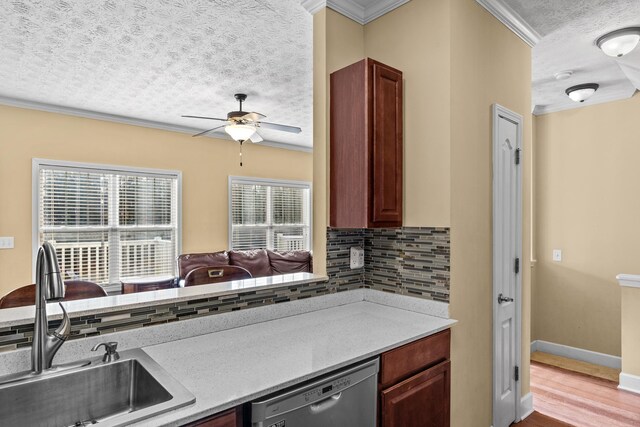 kitchen featuring tasteful backsplash, sink, crown molding, and stainless steel dishwasher