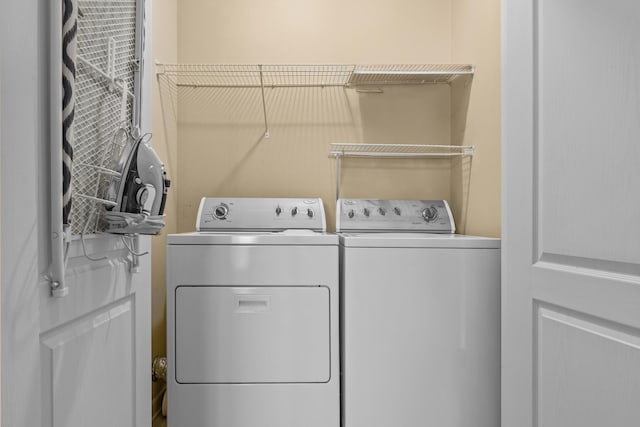 washroom with independent washer and dryer