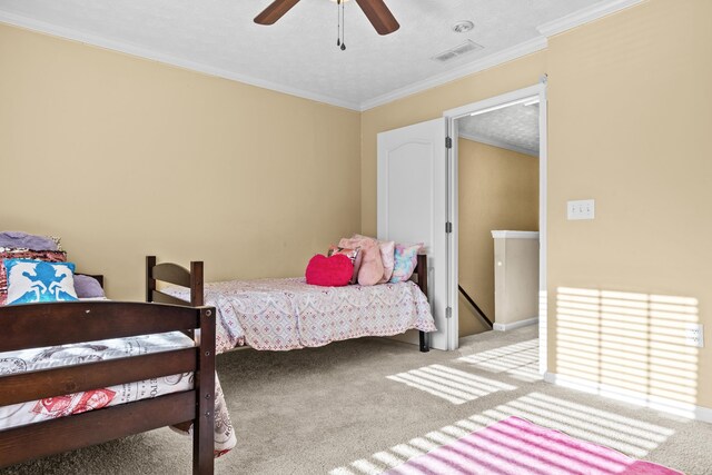 bedroom featuring ceiling fan, ornamental molding, light carpet, and a textured ceiling