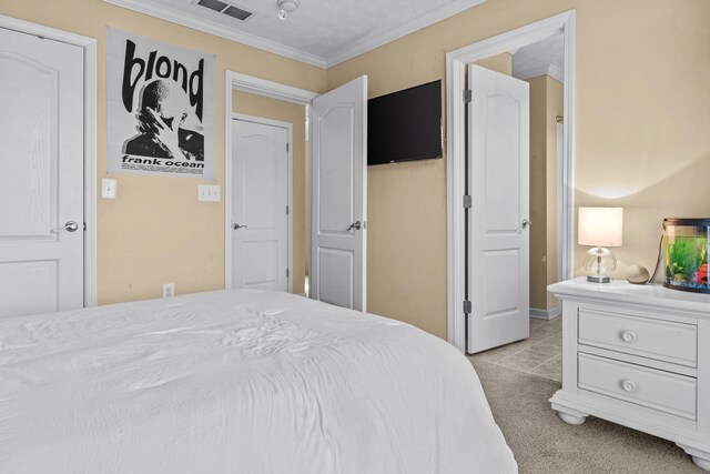 bedroom featuring ornamental molding and light colored carpet