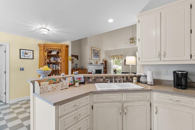 1027 Harper St, Madison, GA 30650 - kitchen with light floors, a peninsula, a ceiling fan, light countertops, and recessed lighting