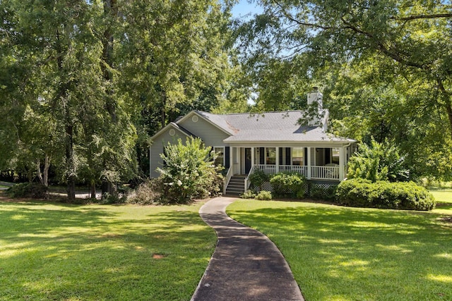 1027 Harper St, Madison, GA 30650 - view of front of house with a porch, a chimney, and a front lawn