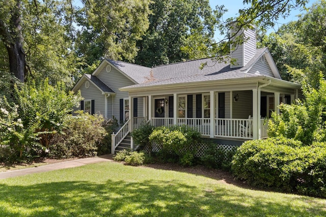 1027 Harper St, Madison, GA 30650 - view of front facade with a porch, a front yard, a chimney, and roof with shingles