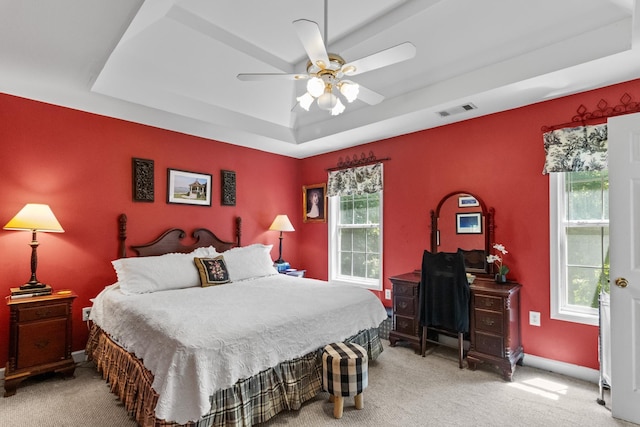 1027 Harper St, Madison, GA 30650 - carpeted bedroom featuring a raised ceiling and a ceiling fan