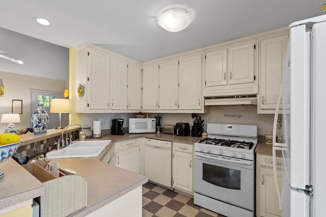1027 Harper St, Madison, GA 30650 - kitchen with white appliances, tile patterned floors, a peninsula, under cabinet range hood, and recessed lighting