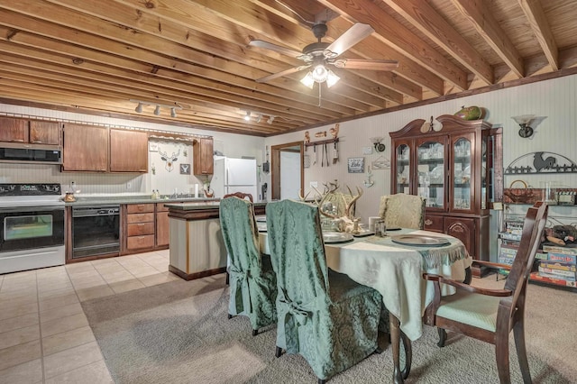 tiled dining space featuring beamed ceiling, wooden ceiling, and ceiling fan