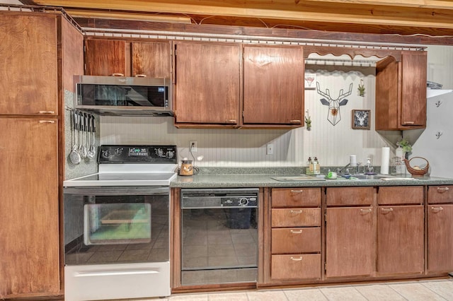 kitchen with range with electric cooktop, sink, dishwasher, and light tile patterned floors