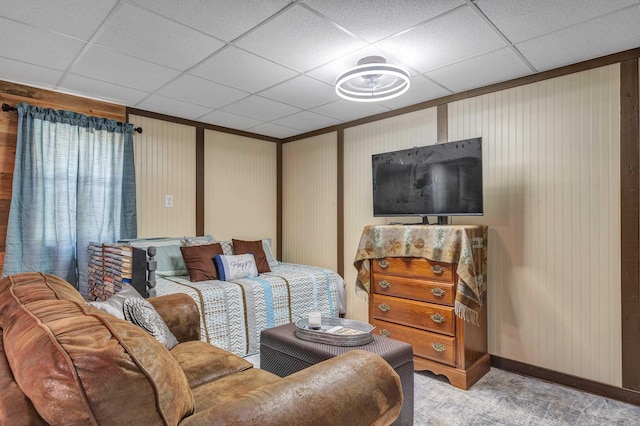 living room featuring a paneled ceiling and light colored carpet