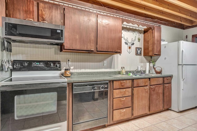 kitchen with light tile patterned floors, range with electric stovetop, dishwasher, and white fridge