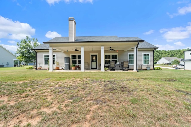 165 Hunters Chase Ct, Eatonton, GA 31024 - rear view of house featuring ceiling fan, a patio, a lawn, and a chimney