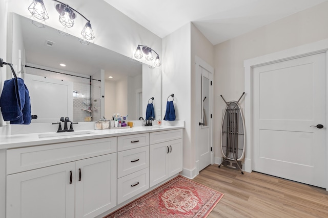 165 Hunters Chase Ct, Eatonton, GA 31024 - full bathroom with a stall shower, double vanity, wood finished floors, and recessed lighting